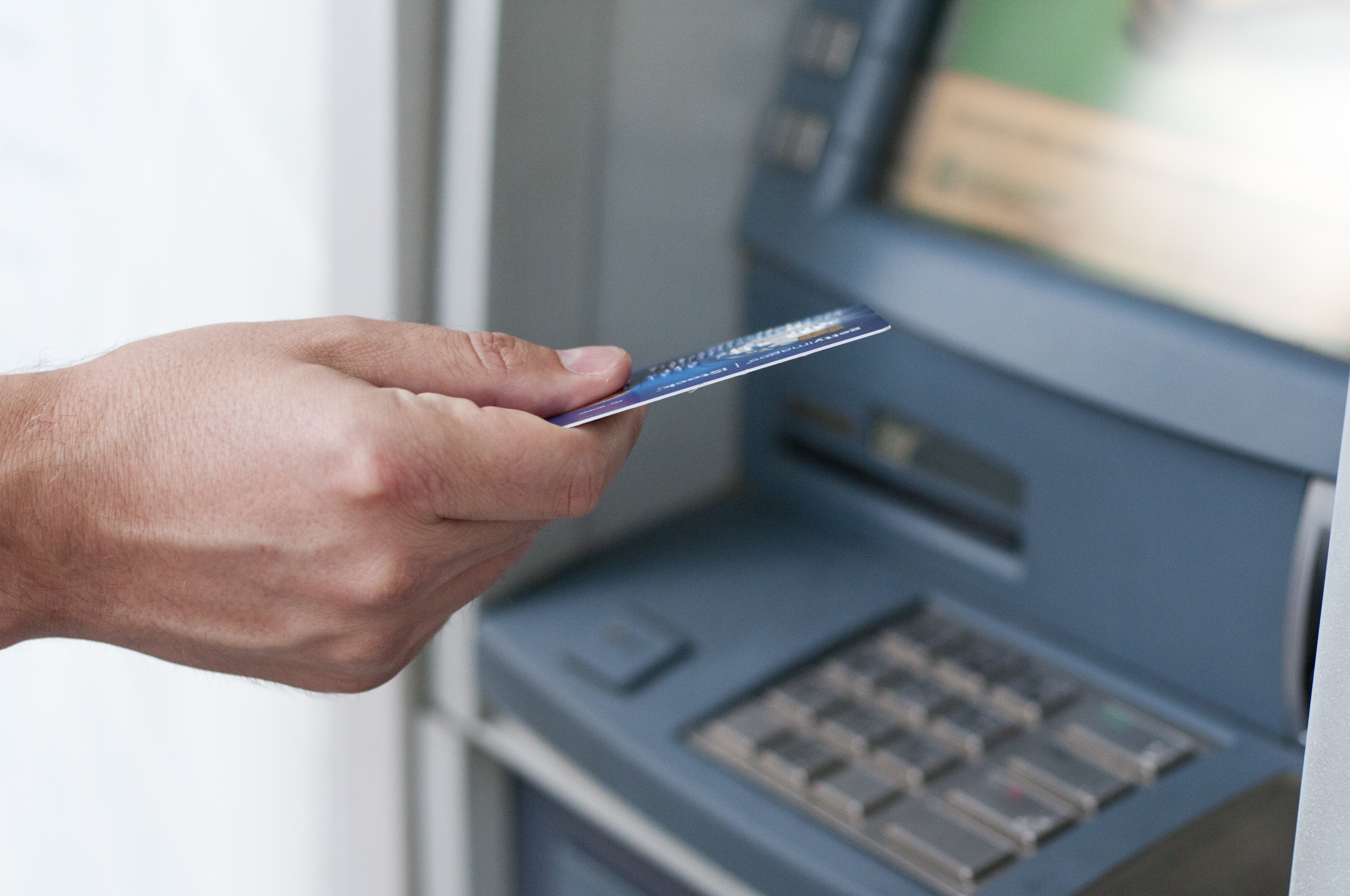 hand-inserting-atm-card-into-bank-machine-withdraw-money-businessman-men-hand-puts-credit-card-into-atm